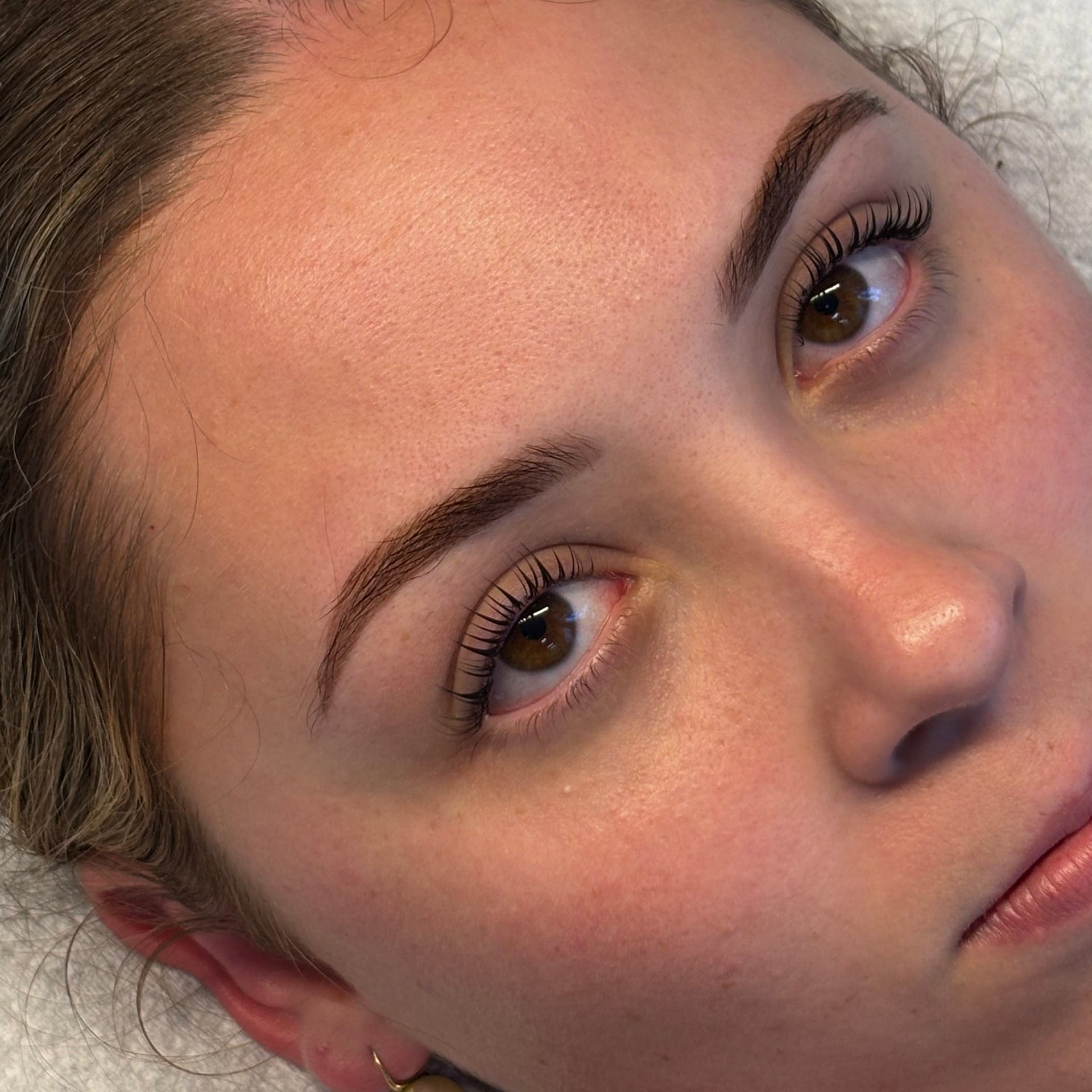 A client after lash and brow work at SHE Day Spa